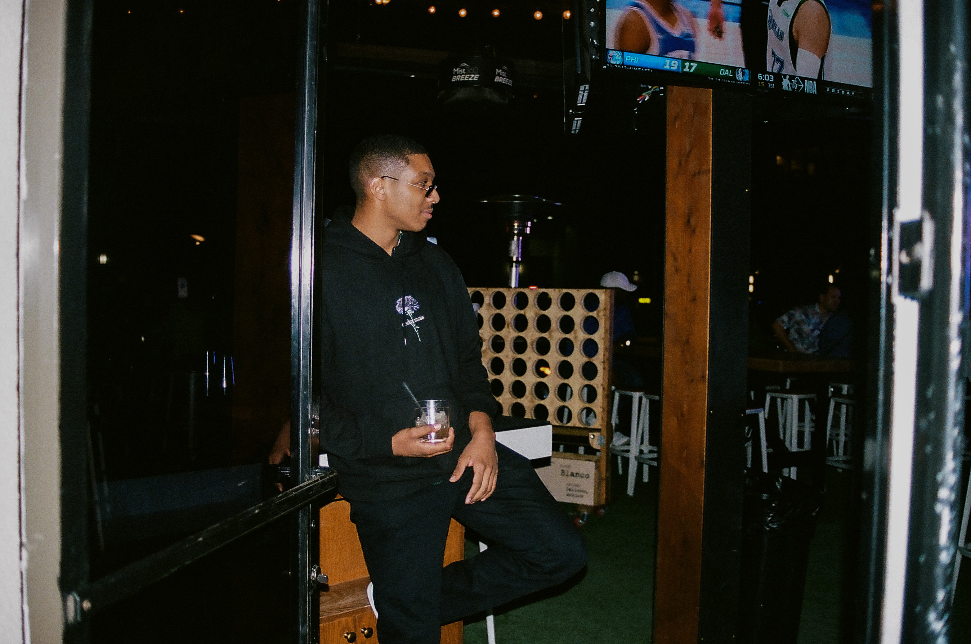 Friend poses with his drink in a doorway inside Hot Chick in Old Town Scottsdale, Arizona.