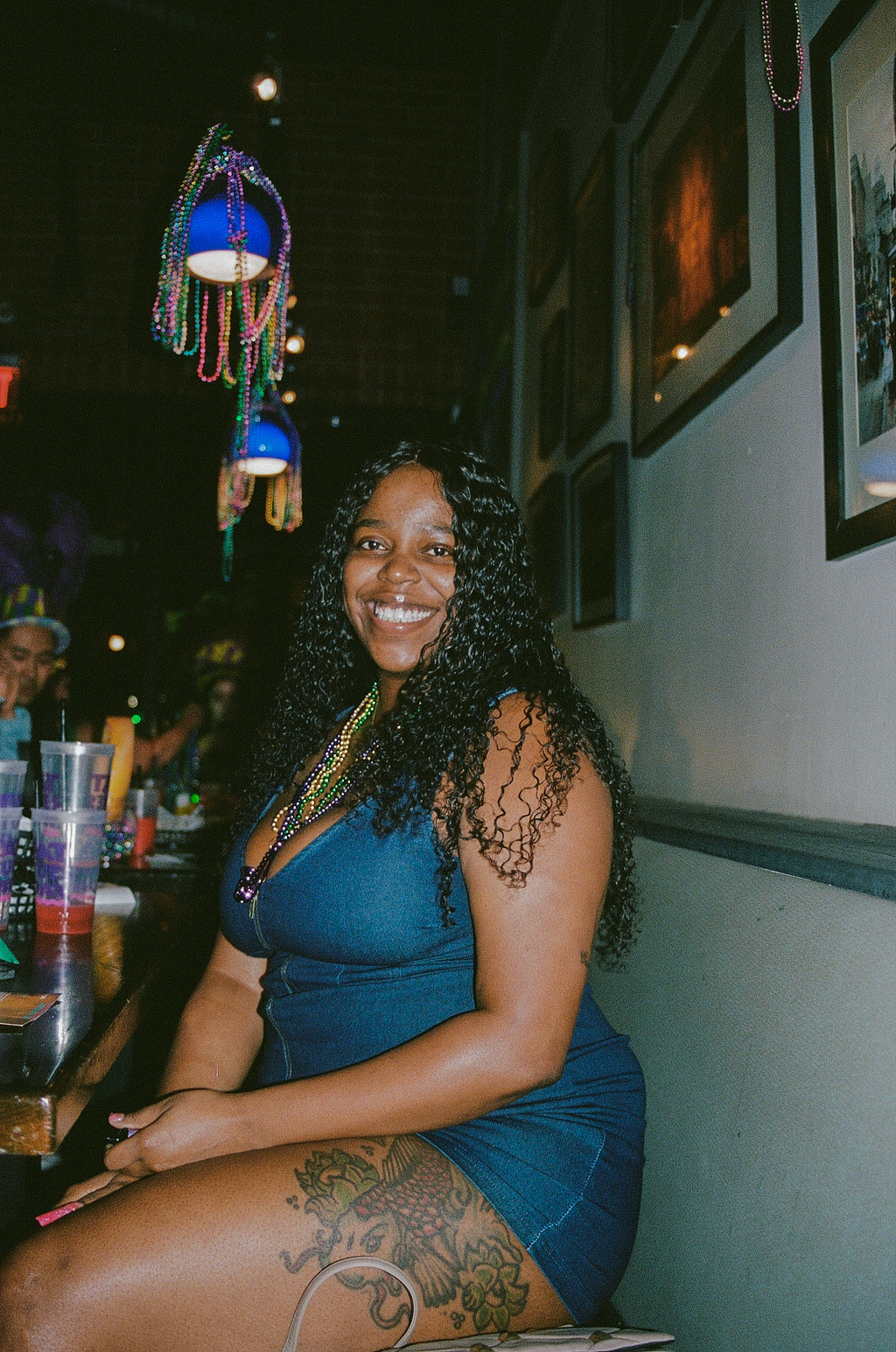 Woman smiles for a photo during Mardi Gras celebrations at Fat Tuesday on Mill Avenue in Downtown Tempe.