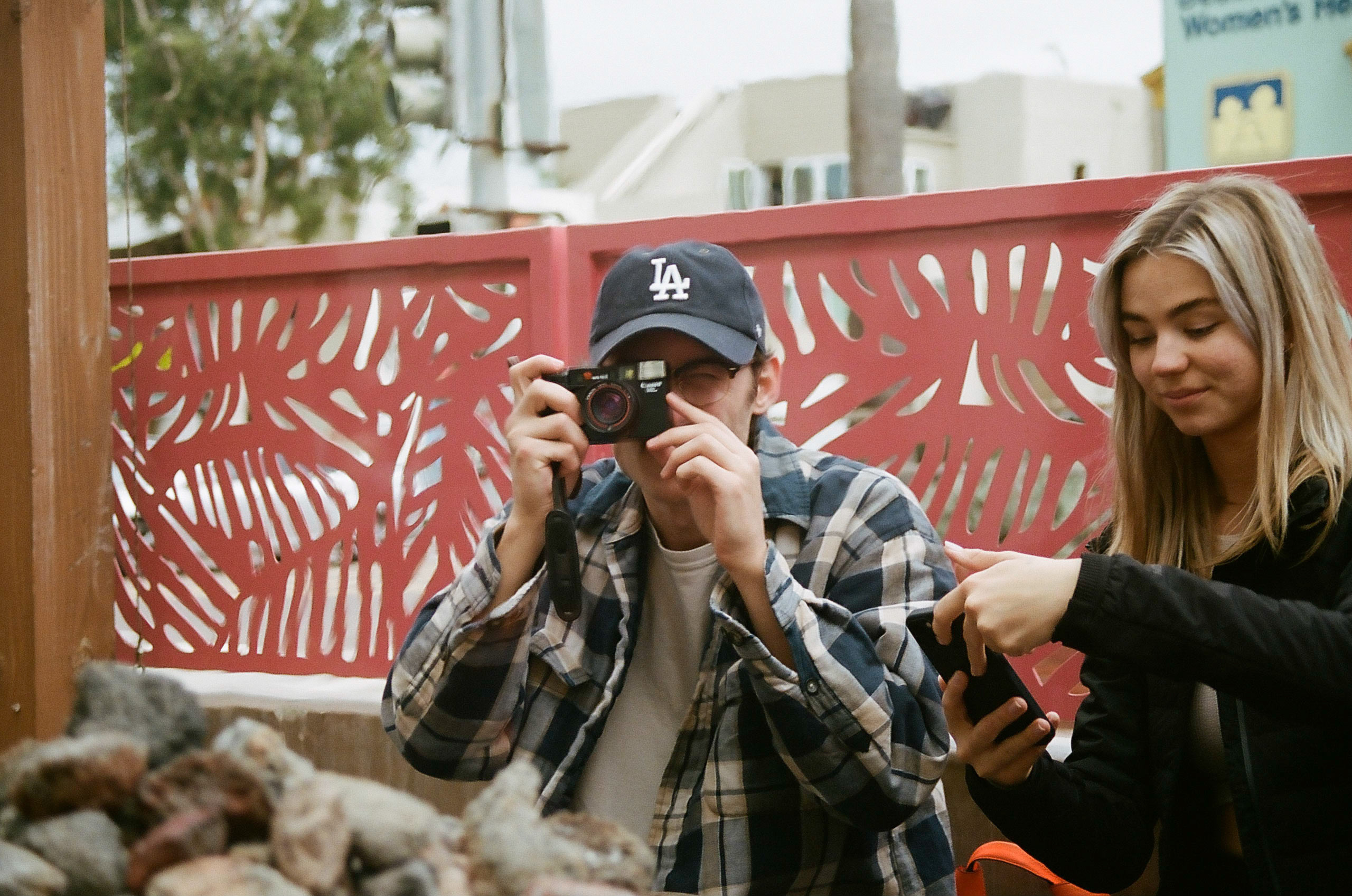 Friend plays around with another's camera while at brunch