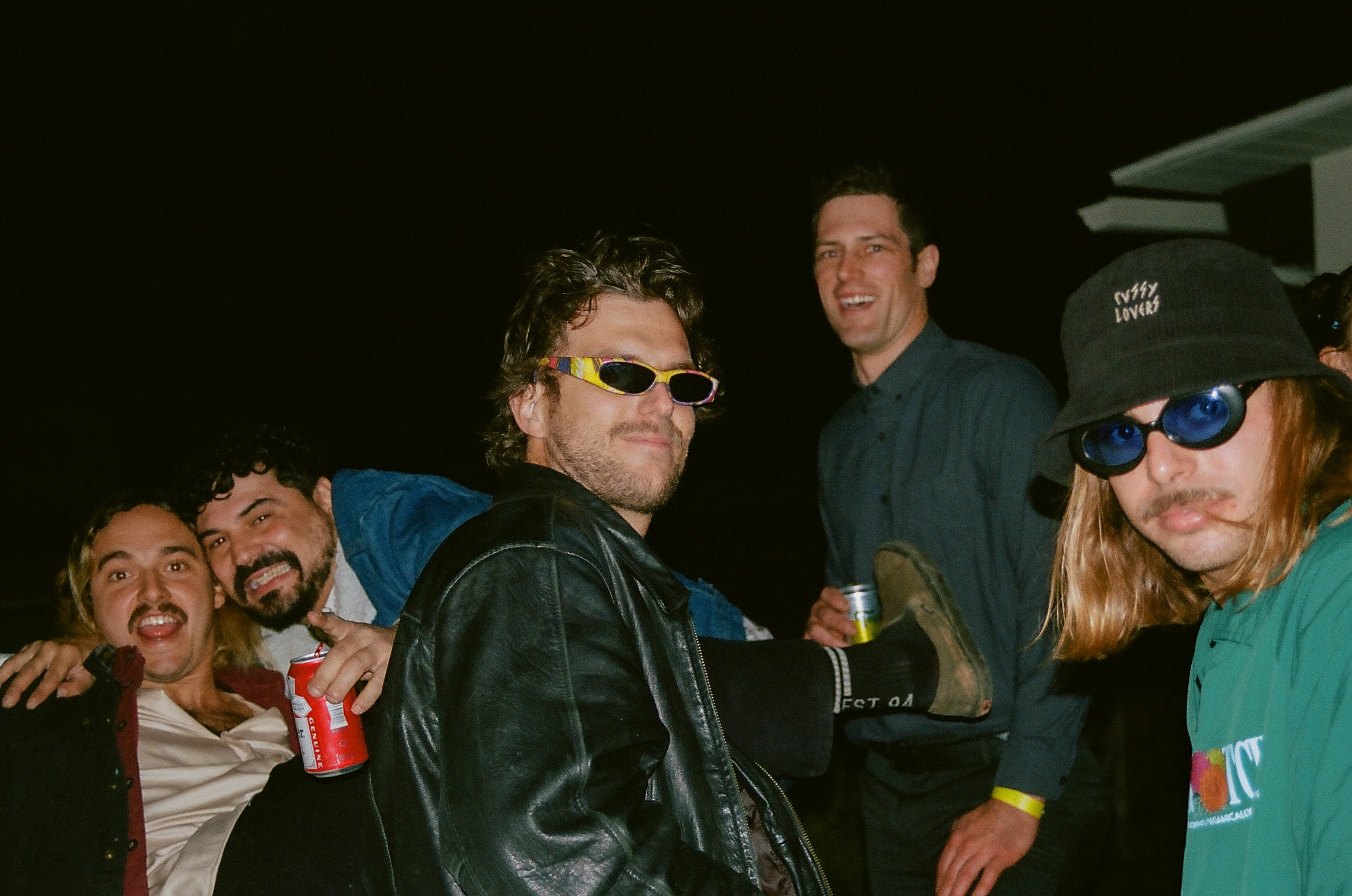 Five men pose for a photo.