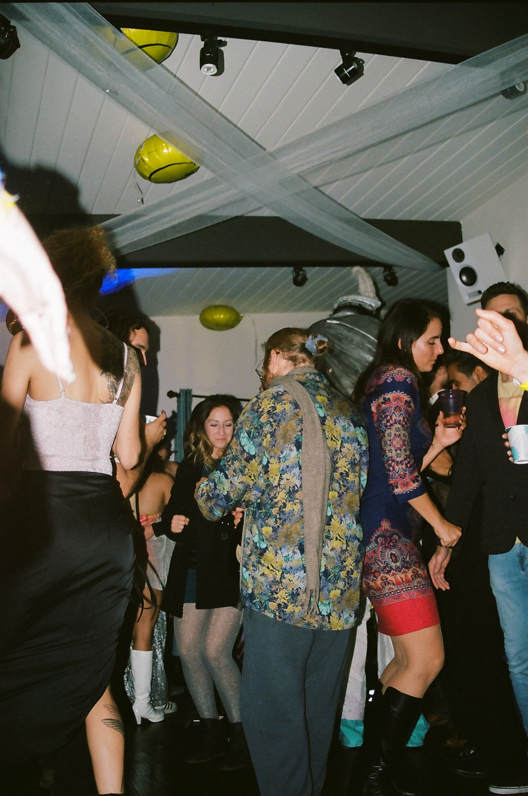 Partygoers dance amongst one another on the dancefloor.