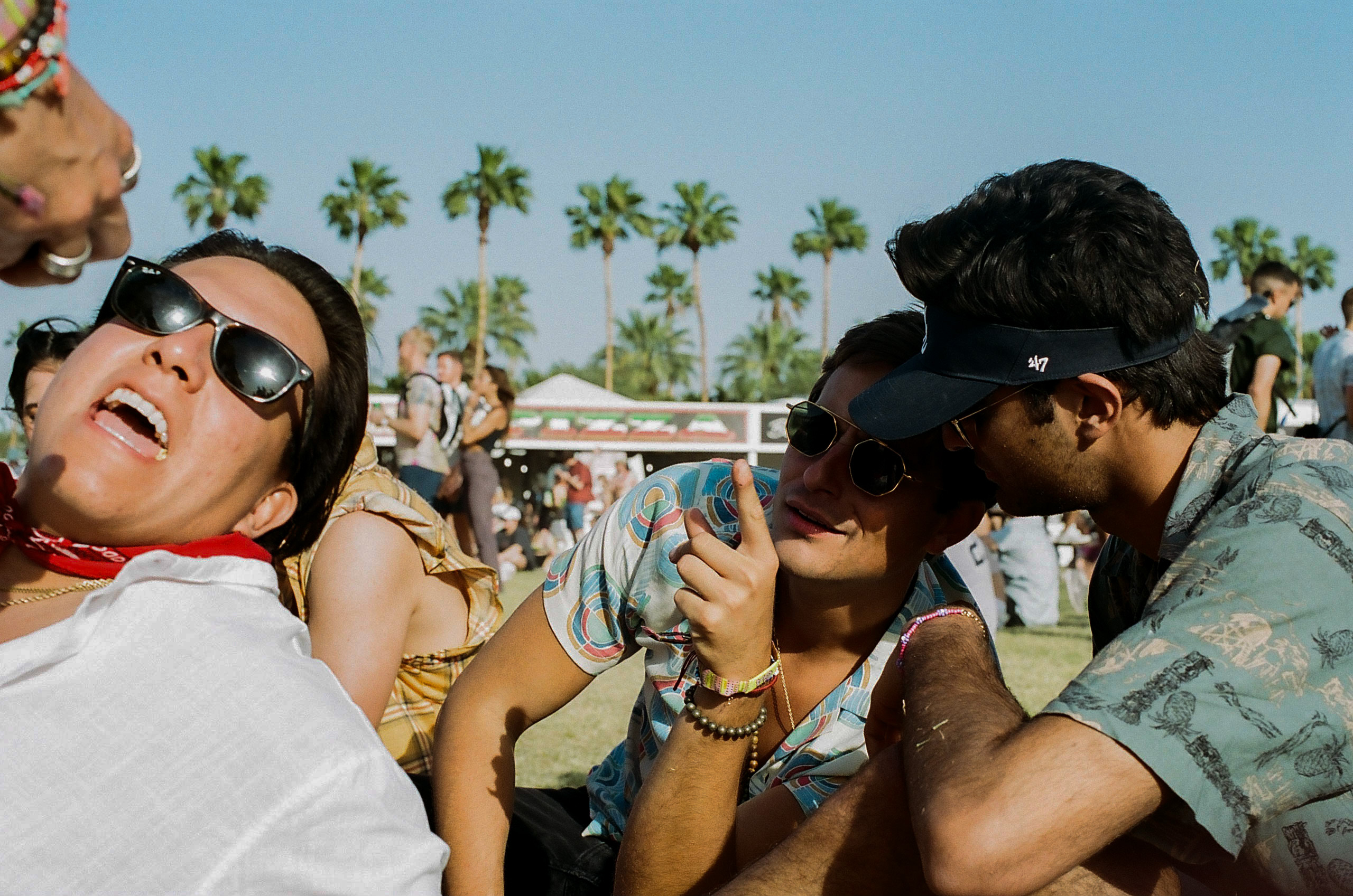 Friends sitting and relaxing in the beer garden at Coachella Valley Music and Arts Festival 2022.