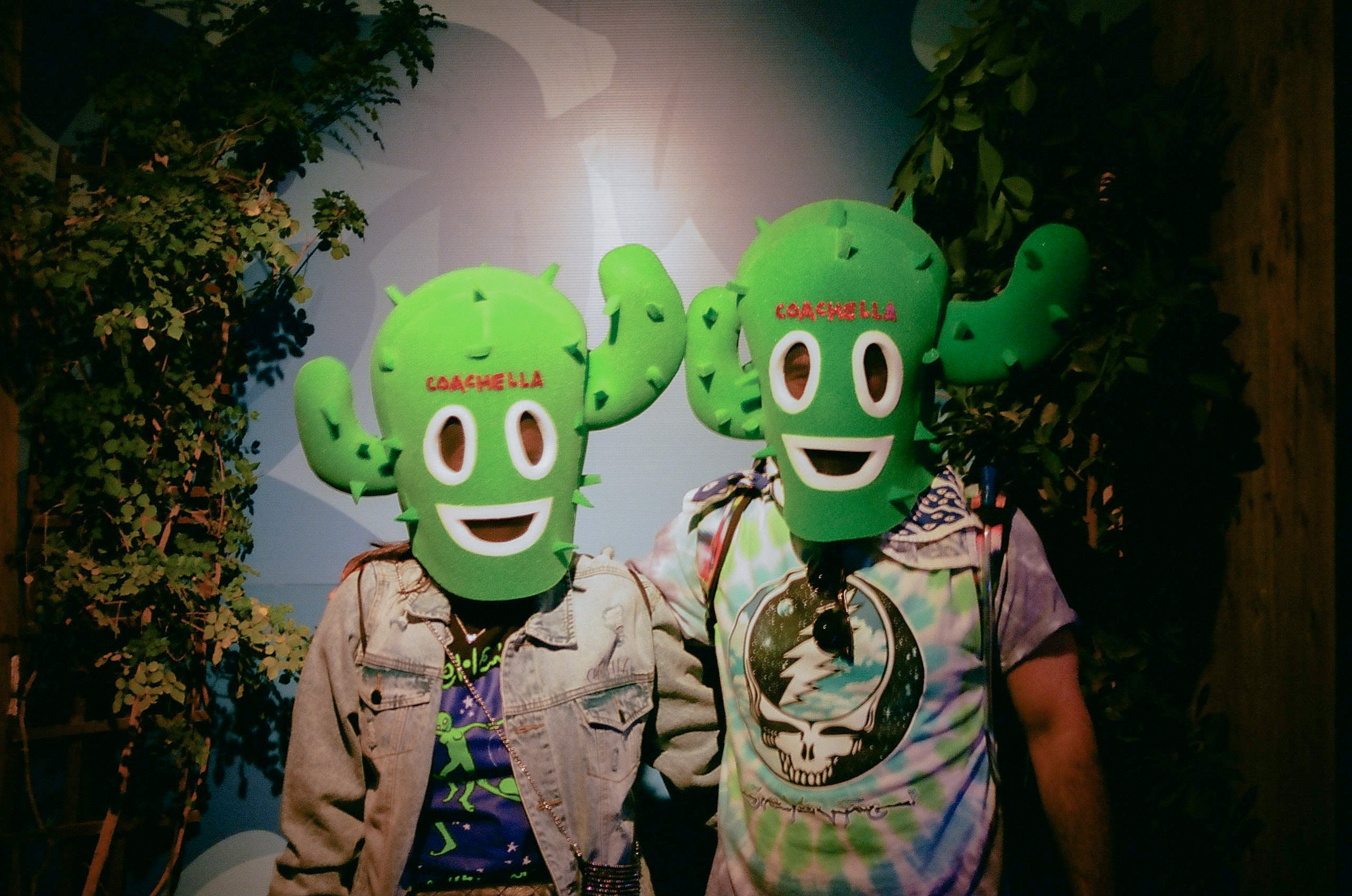 Two people pose wearing their custom cactus Coachella x Nicholas Mayfield Ski Mask at Coachella Valley Music and Arts Festival 2022.