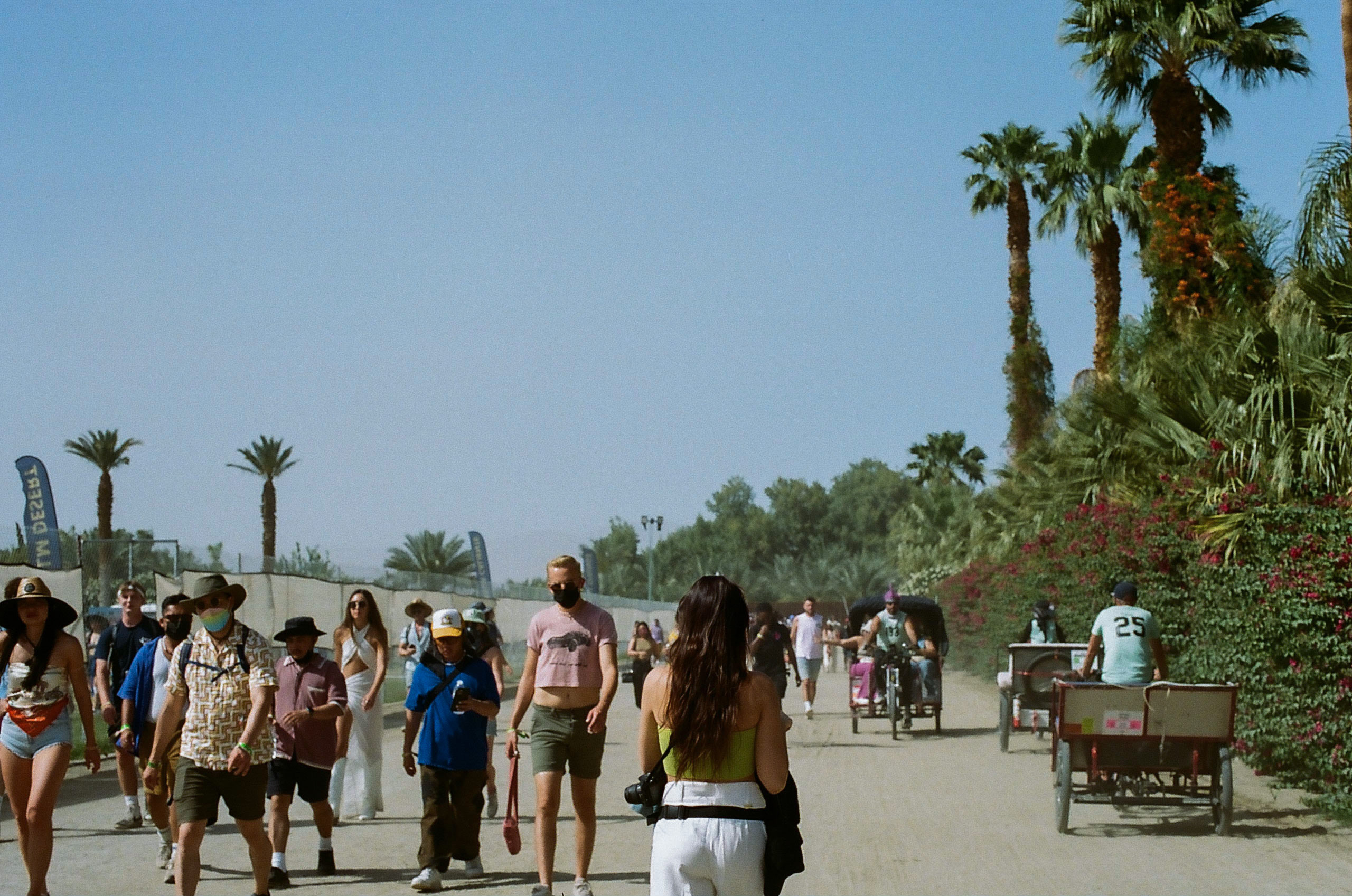 Sister walking to the entrance of the festival from the shuttle bus drop-off at Coachella Valley Music and Arts Festival 2022.