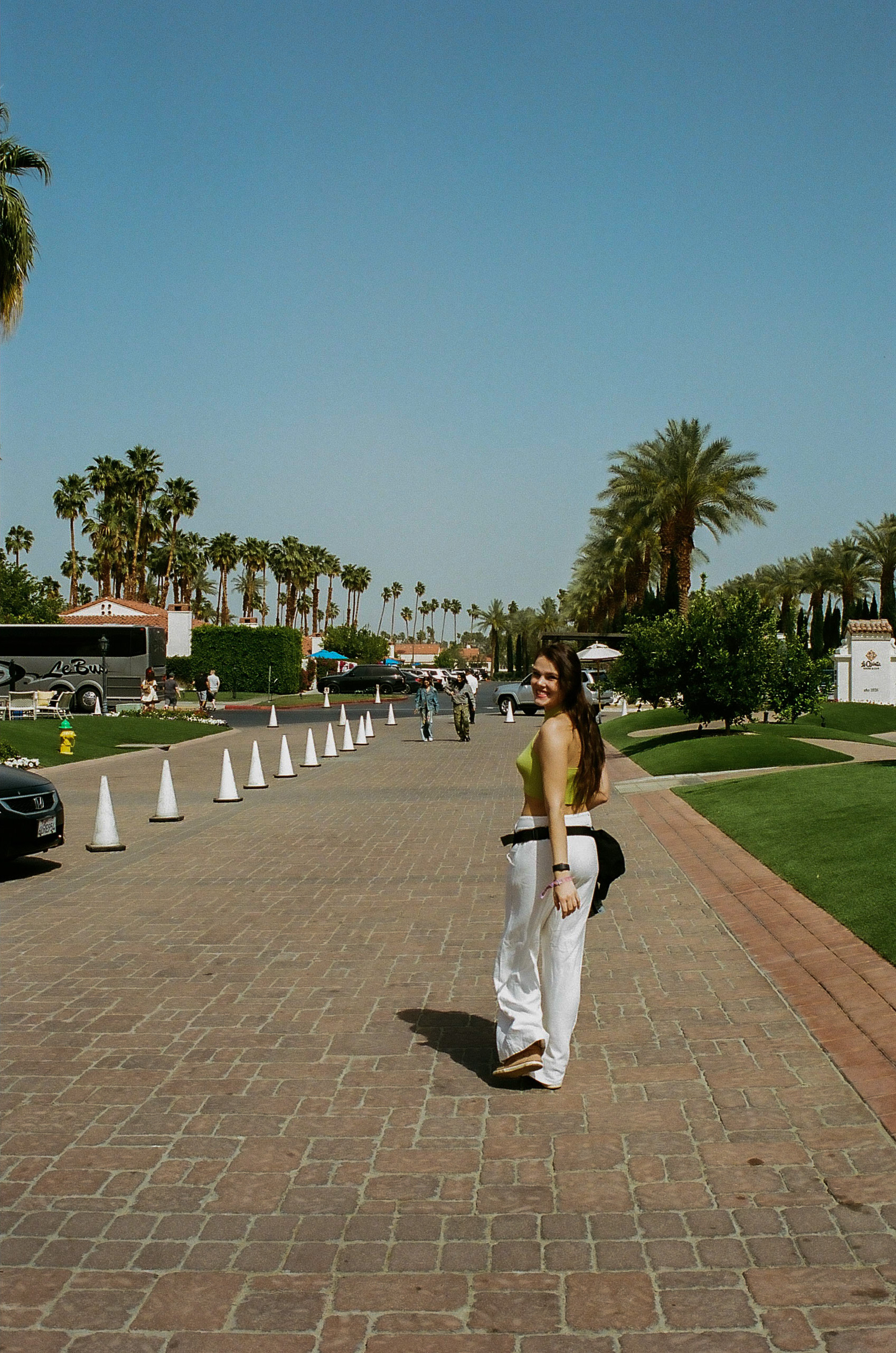 Sister smiles for a photo on the walk to the shuttle buses at Coachella Valley Music and Arts Festival 2022.