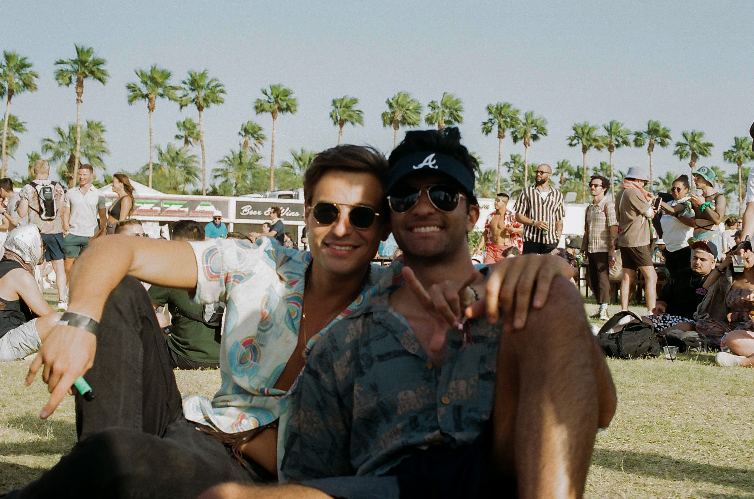 Two friends smile for a photo in the beer garden at Coachella Valley Music and Arts Festival 2022.