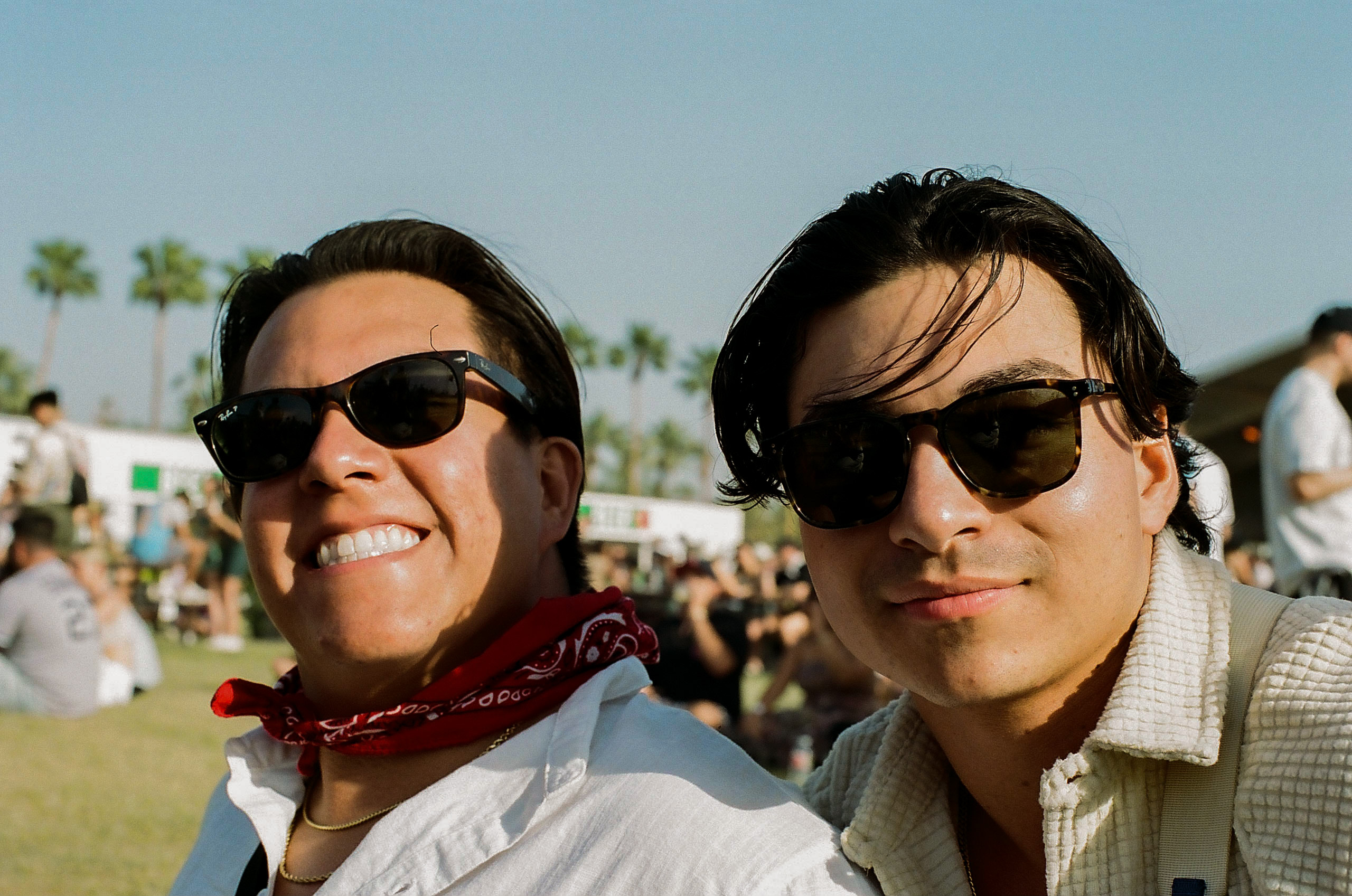 Two friends smile for a photo in the beer garden at Coachella Valley Music and Arts Festival 2022.