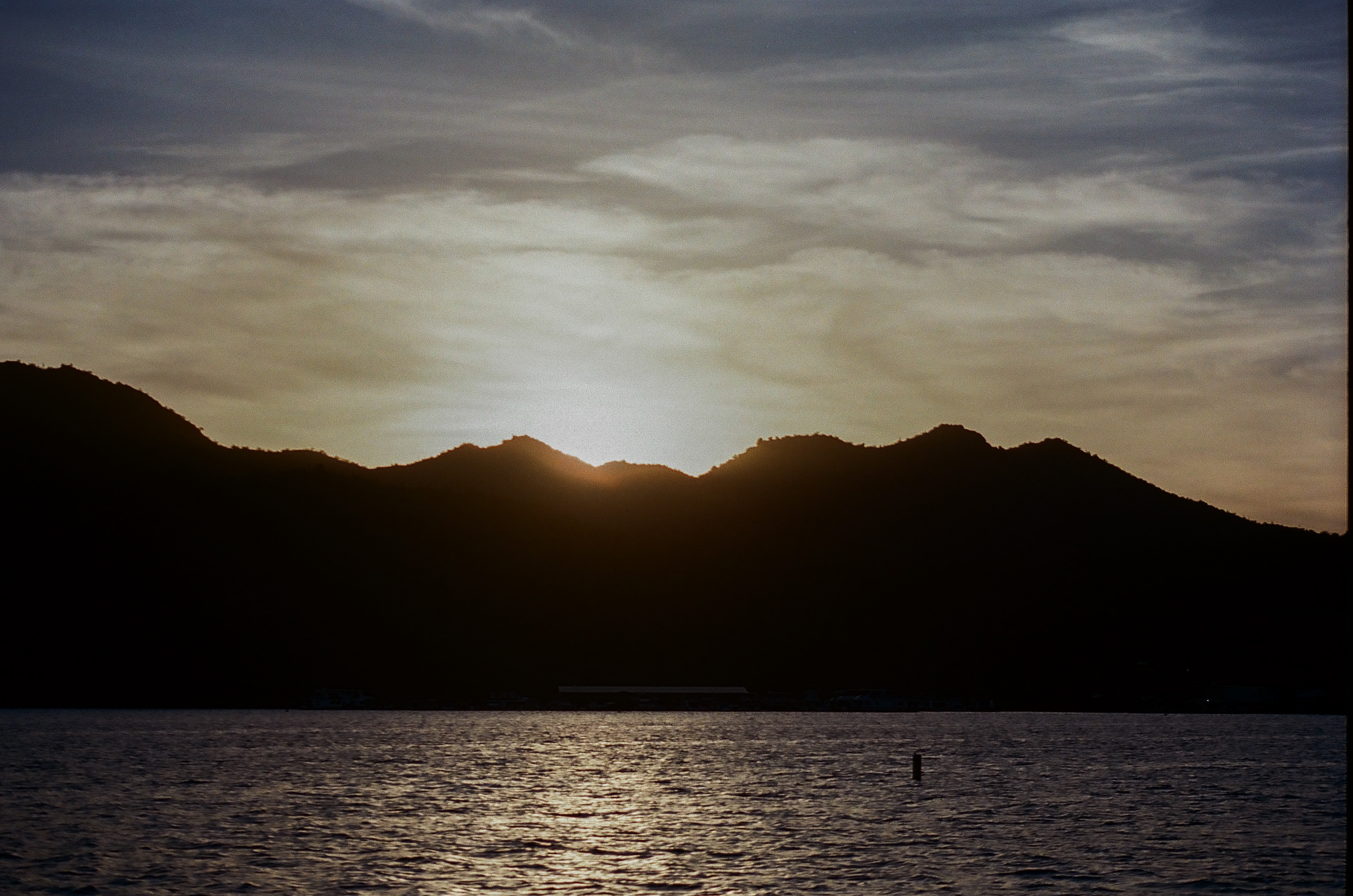 Sun sets behind the mountains along Saguaro Lake.