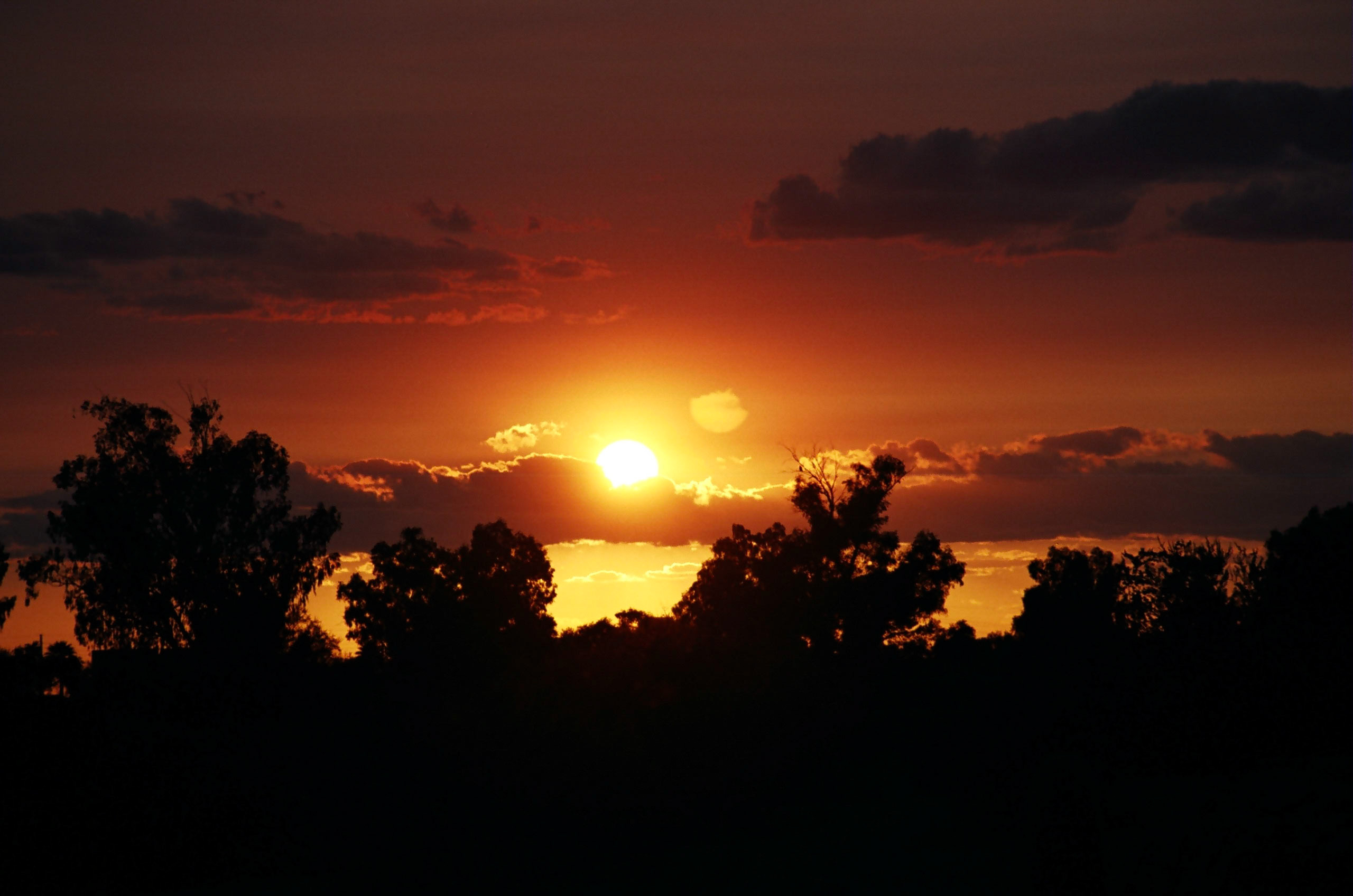 Beautiful sunset at Papago Park turns sky a deep-orange and red color.