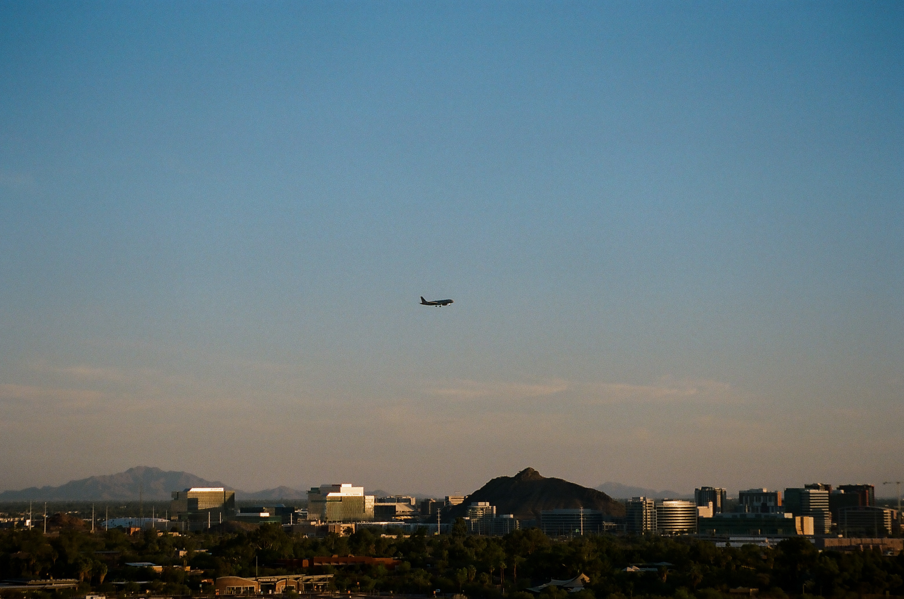 Plane flies over Tempe, Arizona as it prepares to land at Phoenix Sky Harbor airport.